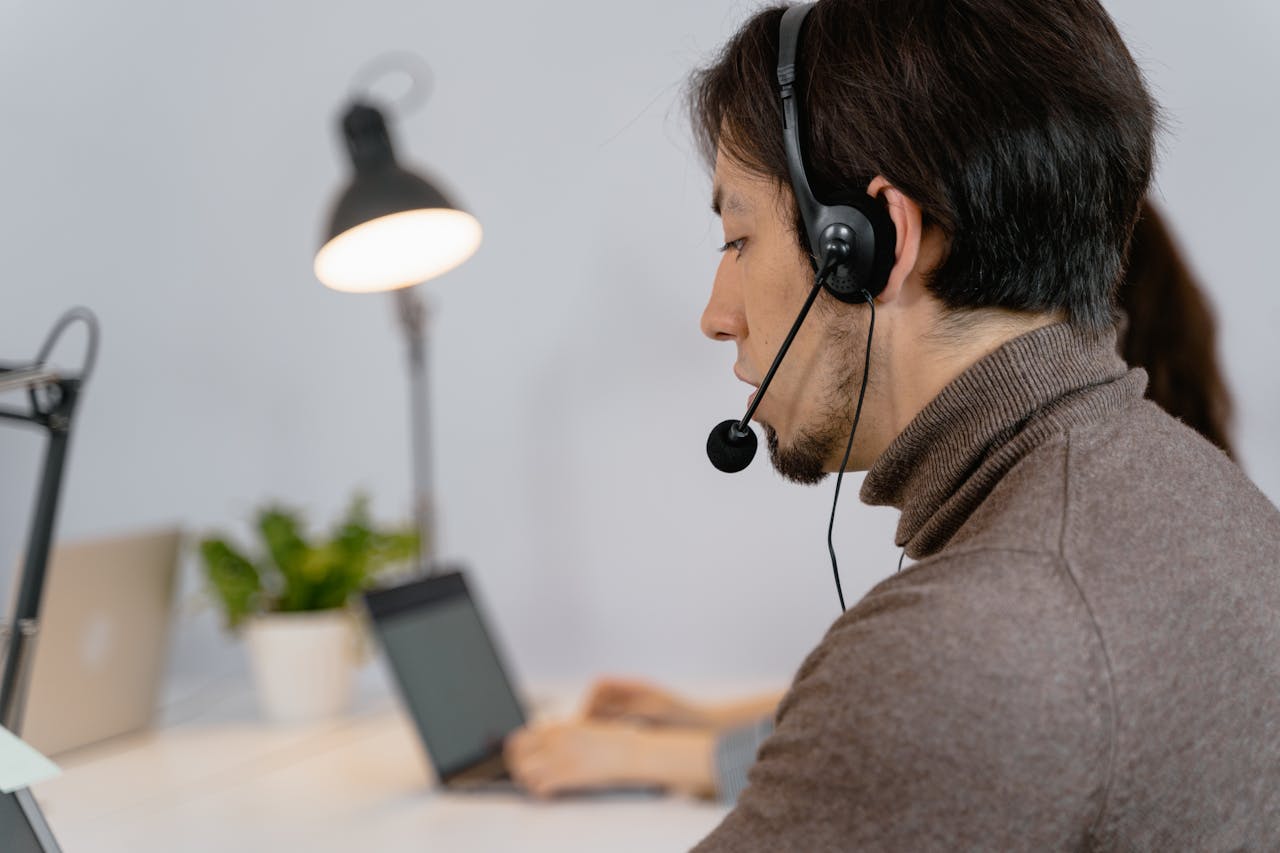 Focused call center agent working with headset, showcasing professional customer support.